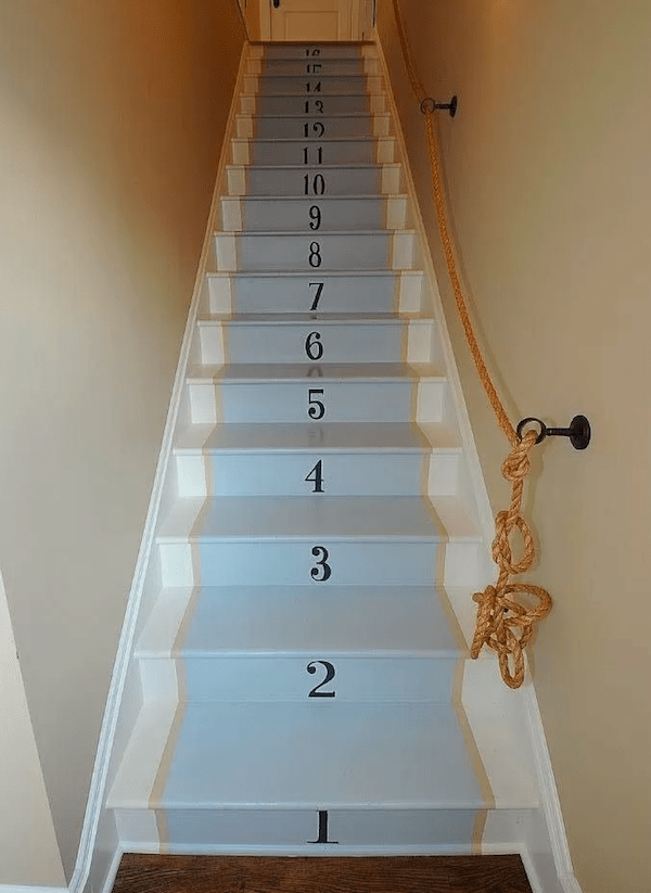 Painted back wood staircase with stenciled numbers